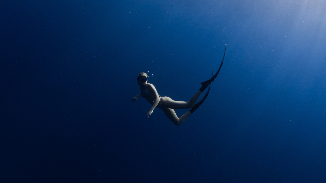 Girl diving under  surface